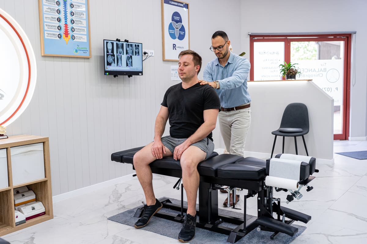 Dr Josh checking a patient’s posture and spine