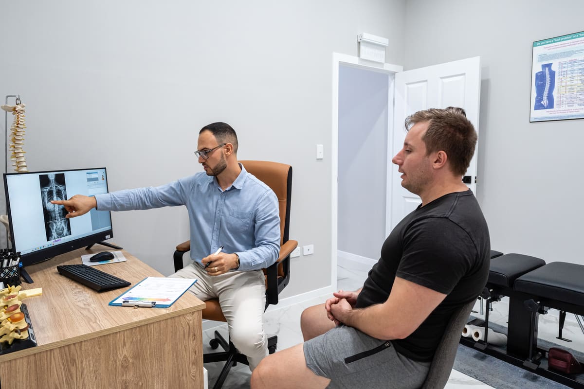 Dr Josh walking a patient through their spinal X-ray