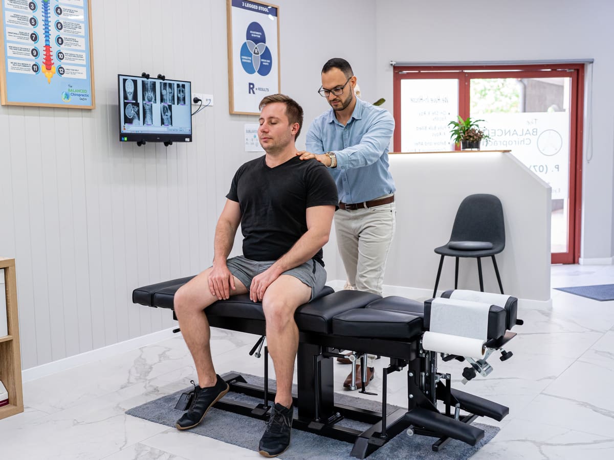 Dr Josh checking a patient’s posture and shoulder alignment